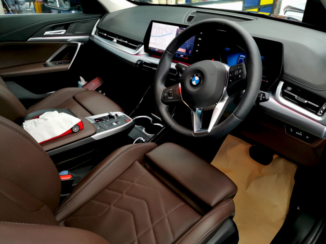 The BMW X1 parked in the workshop, freshly coated.