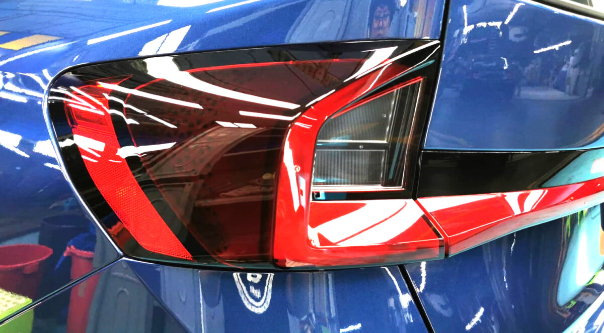 The coated bonnet of the BMW X1 under workshop lighting.