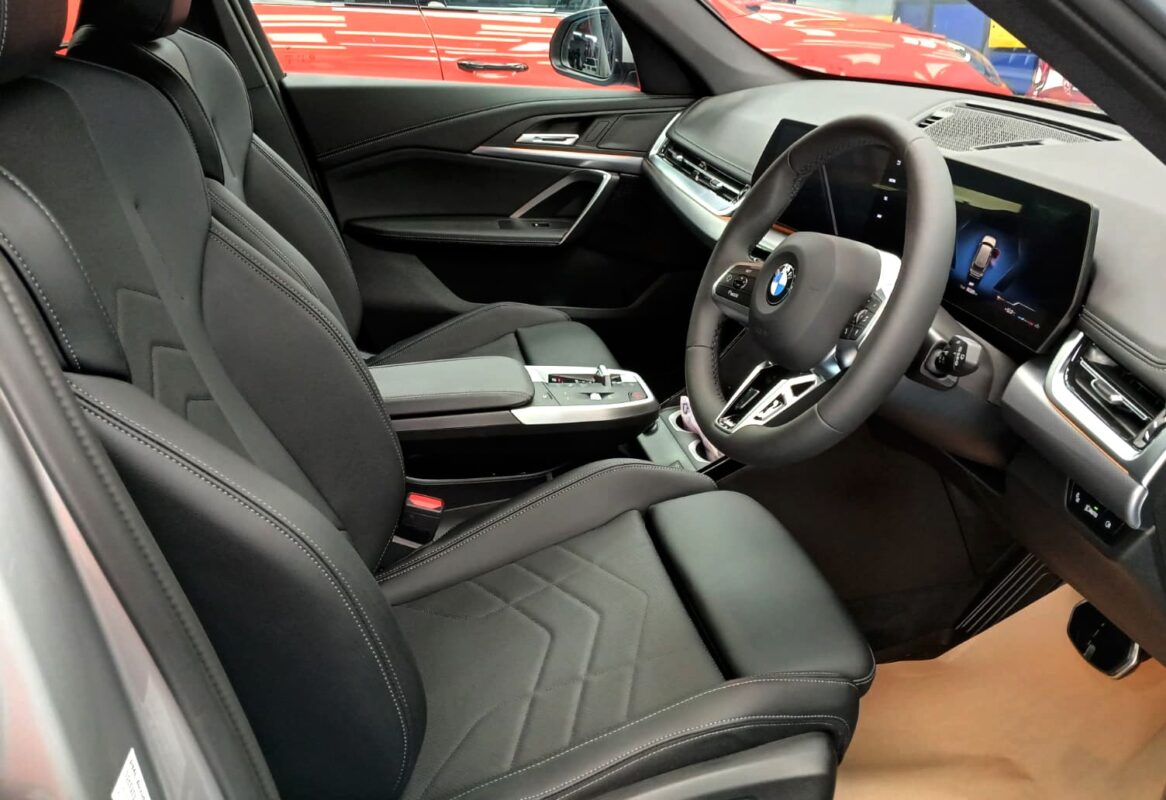 The BMW X1 parked in the workshop, freshly coated.