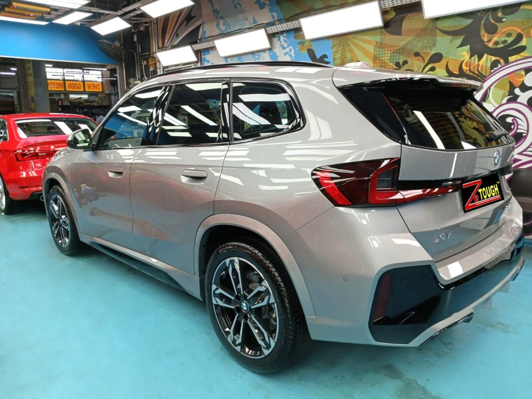 Rear quarter of the BMW X1, glossy and protected.