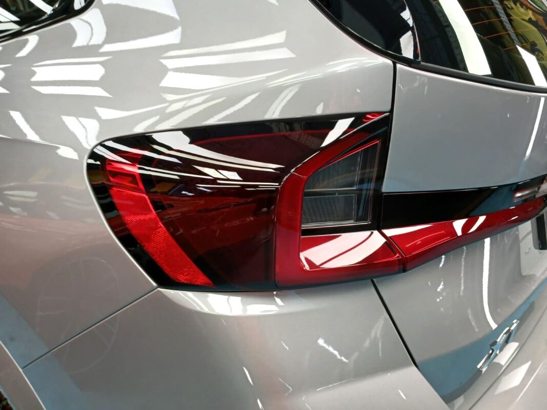The coated bonnet of the BMW X1 under workshop lighting.