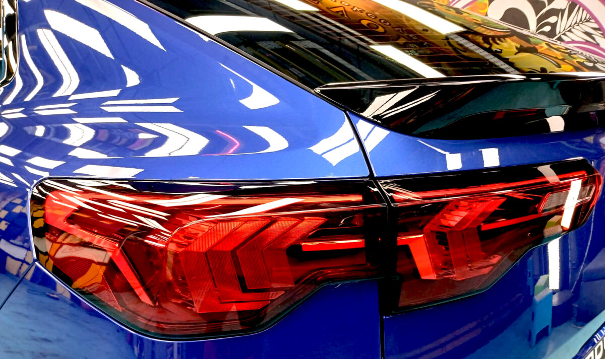 The coated bonnet of the BMW X2 under workshop lighting.