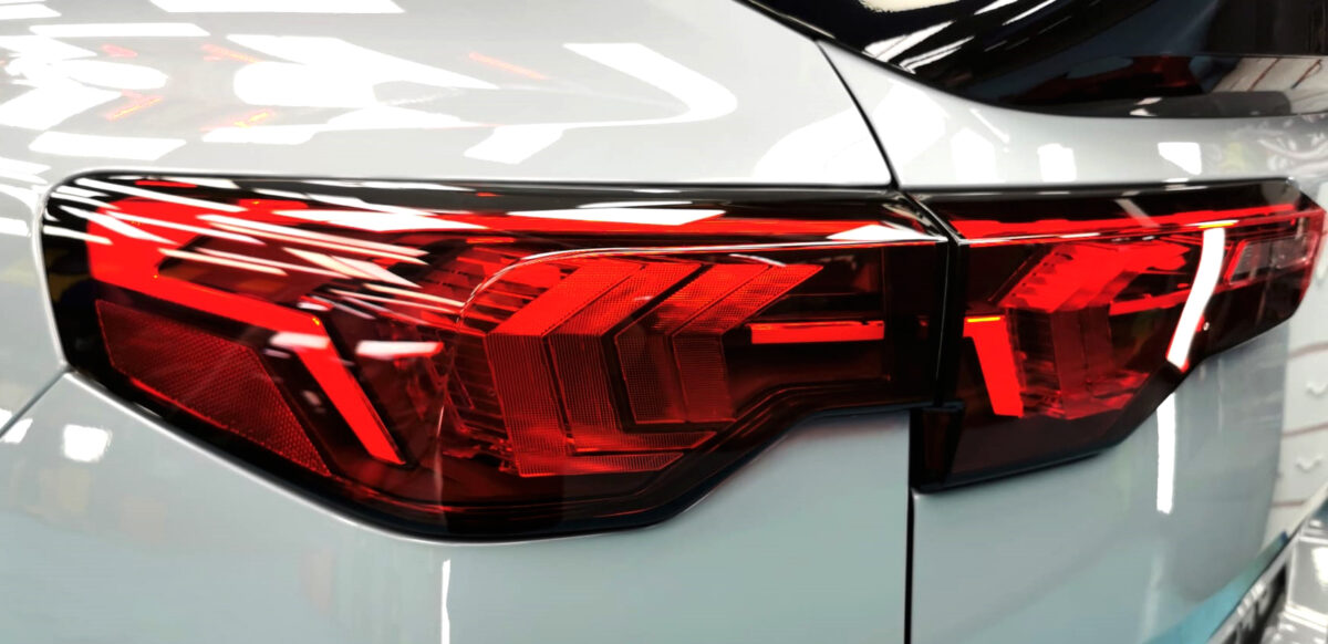 The coated bonnet of the BMW X2 under workshop lighting.