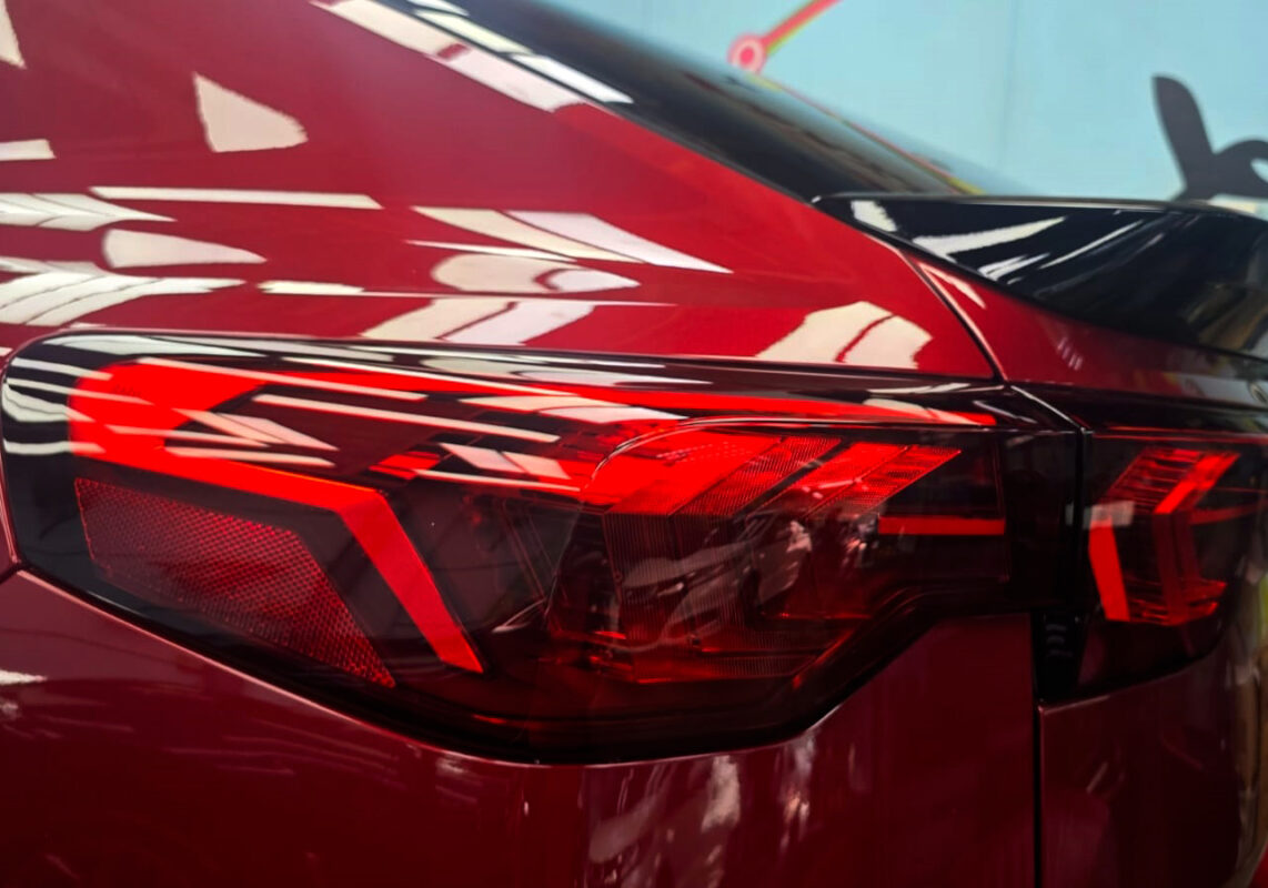 The coated bonnet of the BMW X2 under workshop lighting.