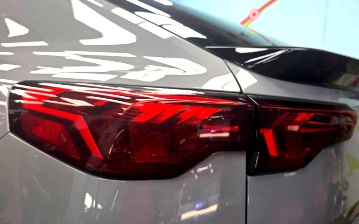 The coated bonnet of the BMW X2 under workshop lighting.