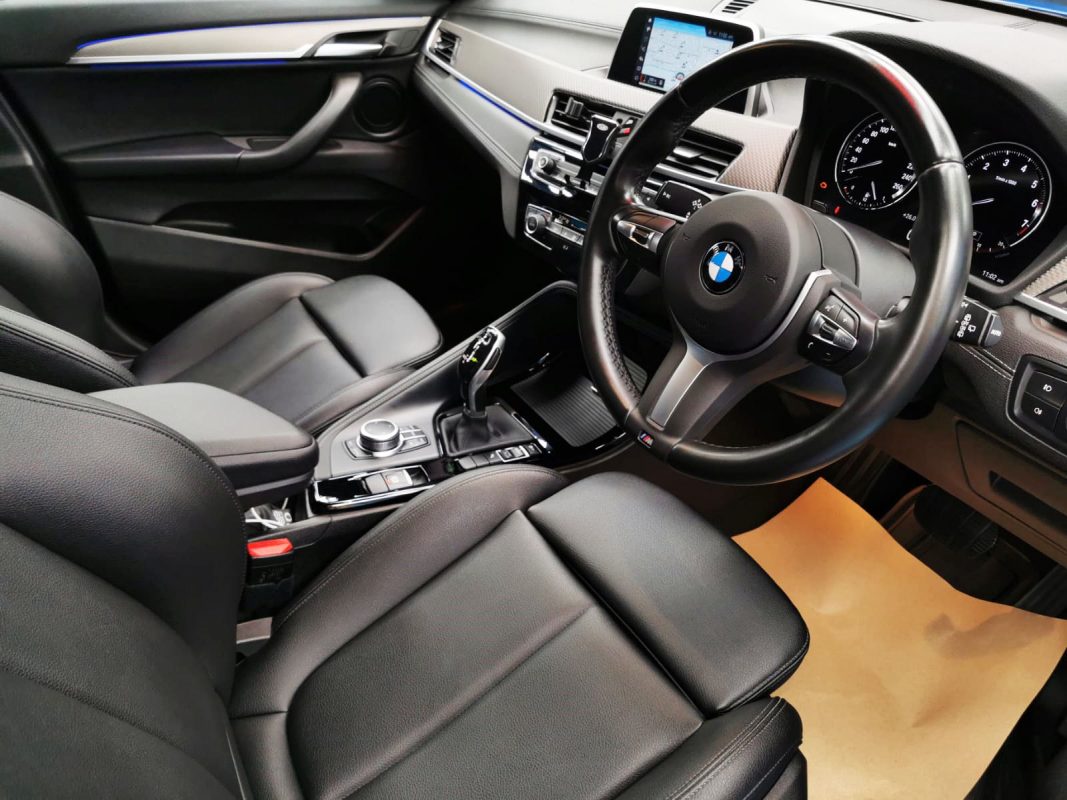 The BMW X2 parked in the workshop, freshly coated.
