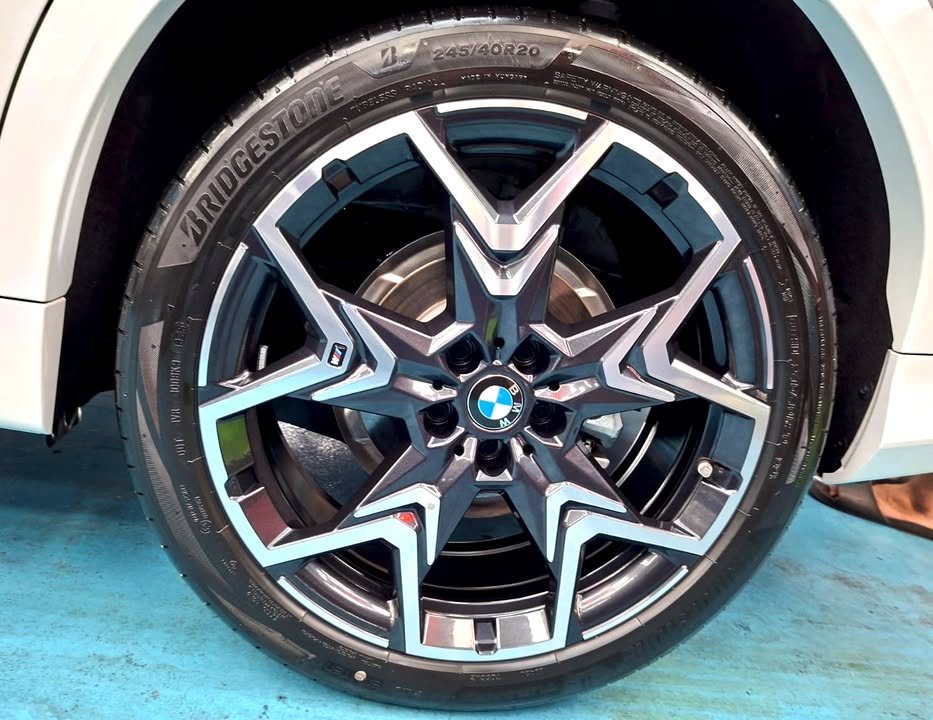 Star-spoke alloy wheel with a BMW centre cap and Bridgestone tyre.
