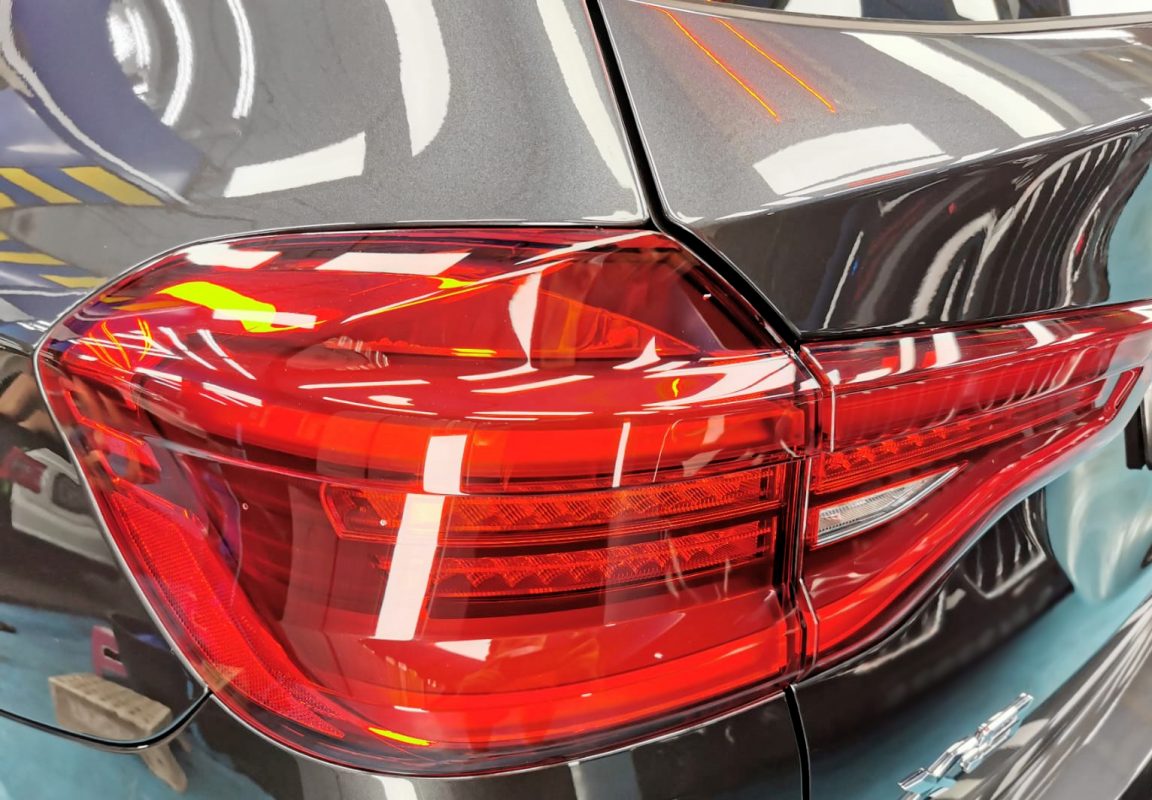 The coated bonnet of the X3 under workshop lighting.
