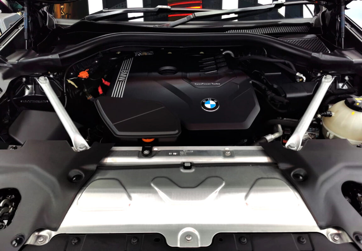 Reflections across the coated panels of the BMW X3.