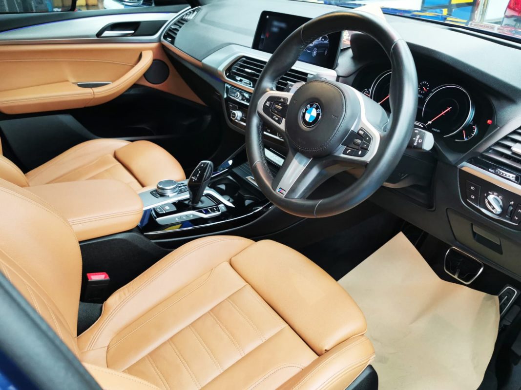 The BMW X3 parked in the workshop, freshly coated.