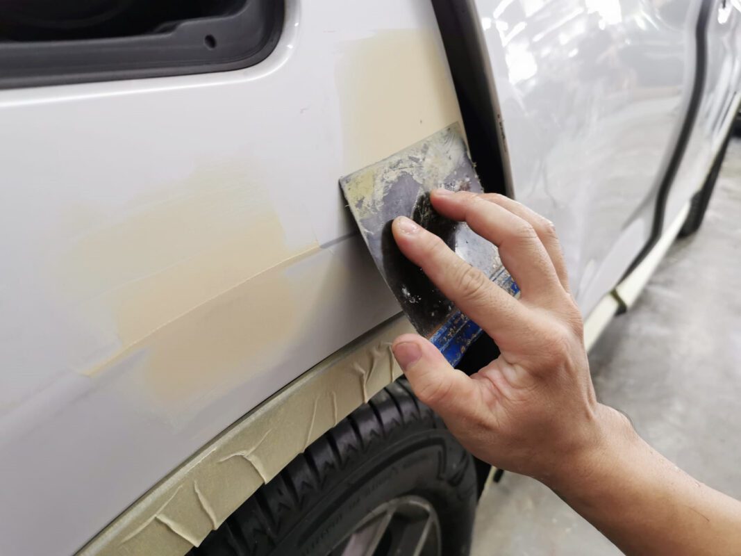 Bodywork and patching on a panel of the BMW X3, imperfections being repaired.