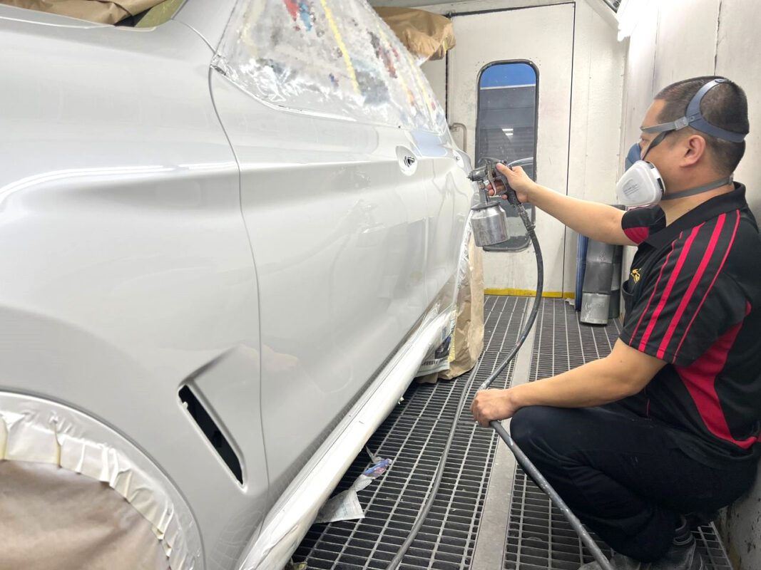 Machine-polishing the BMW X3 after the paint has cured.