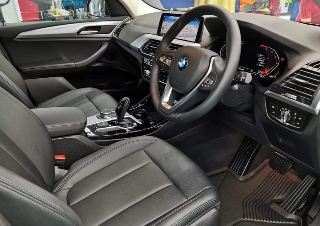 The BMW X3 parked in the workshop, freshly coated.