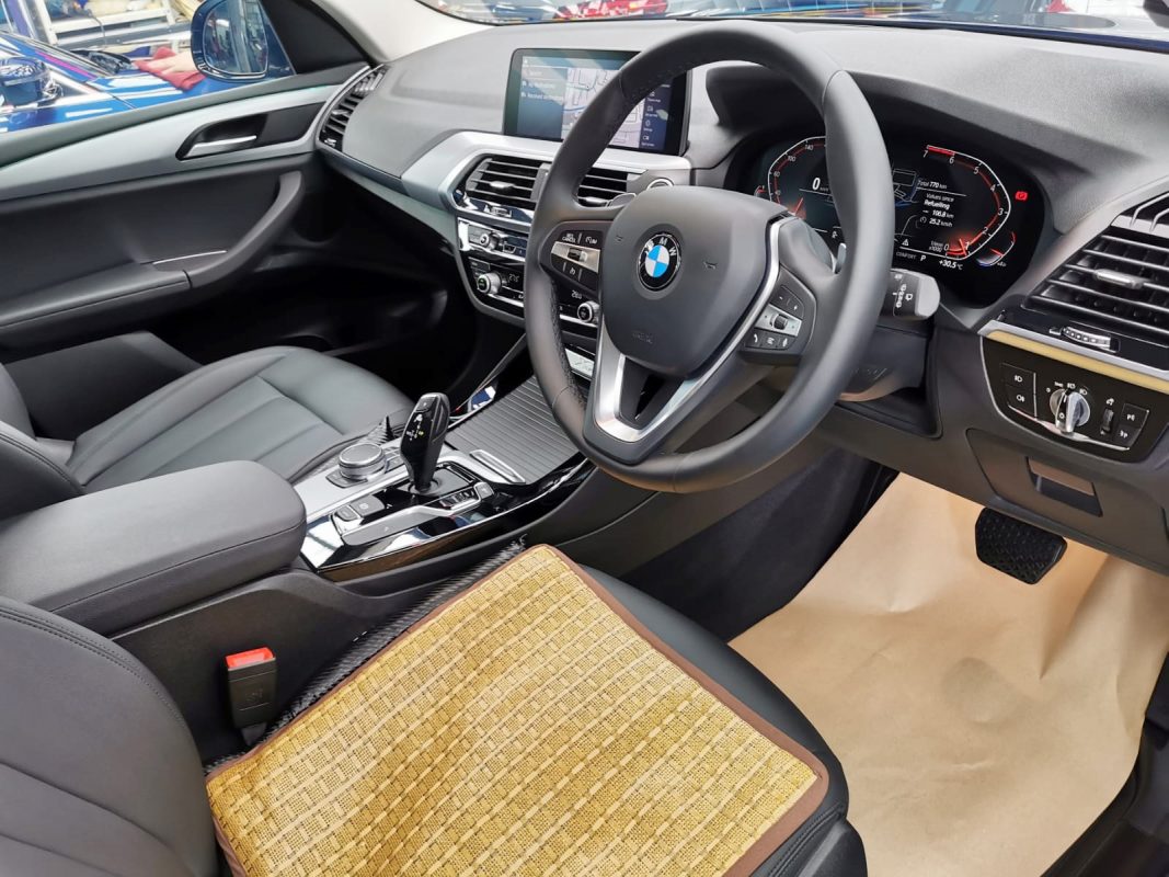 The BMW X3 parked in the workshop, freshly coated.