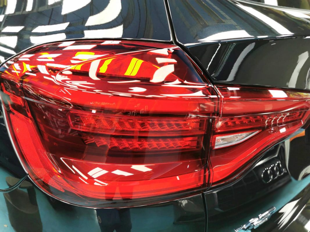 The coated bonnet of the BMW X3 under workshop lighting.