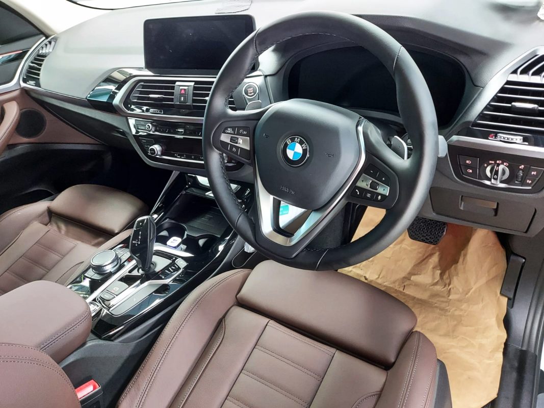 The BMW X3 parked in the workshop, freshly coated.