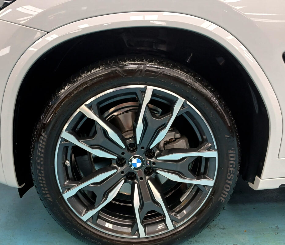 The coated bonnet of the BMW X4 under workshop lighting.