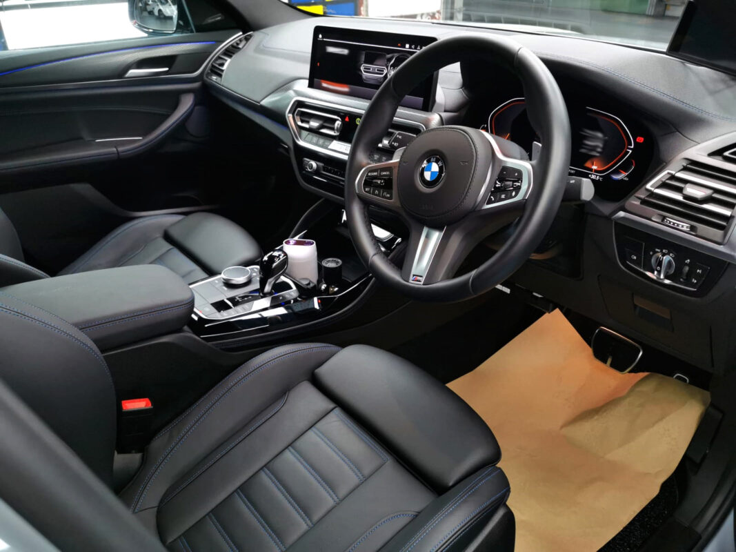 The BMW X4 parked in the workshop, freshly coated.