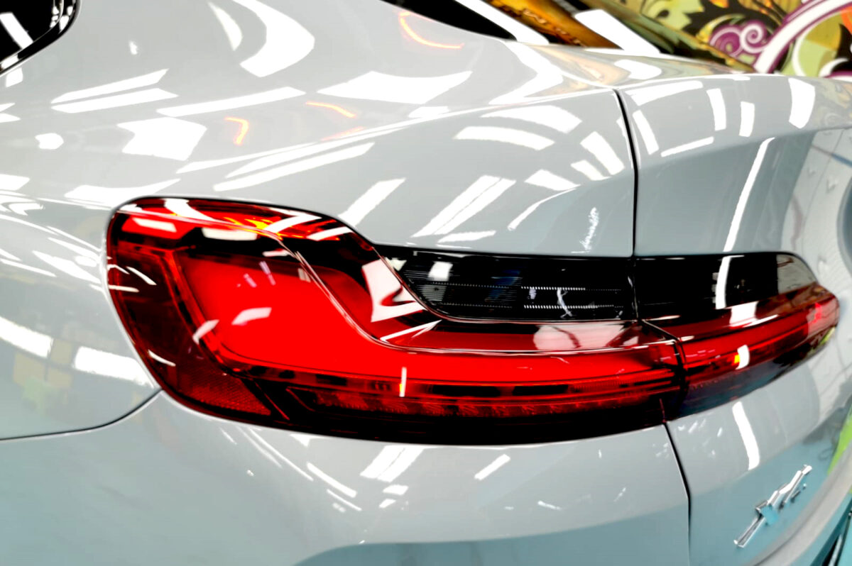The coated bonnet of the BMW X4 under workshop lighting.