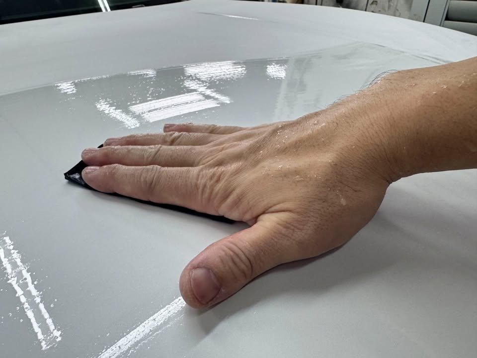 Wet sanding the grey primed bonnet of the X4.