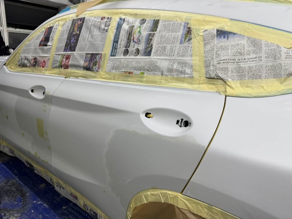 Side of the X4 masked with tape and newspaper over the windows.