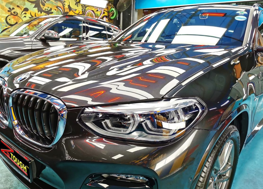 The BMW X4 from a side angle after the titanium coating.