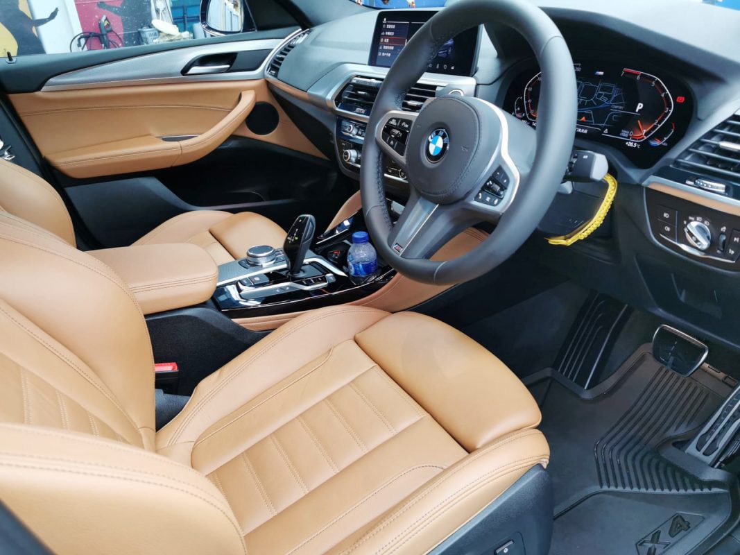 The BMW X4 parked in the workshop, freshly coated.