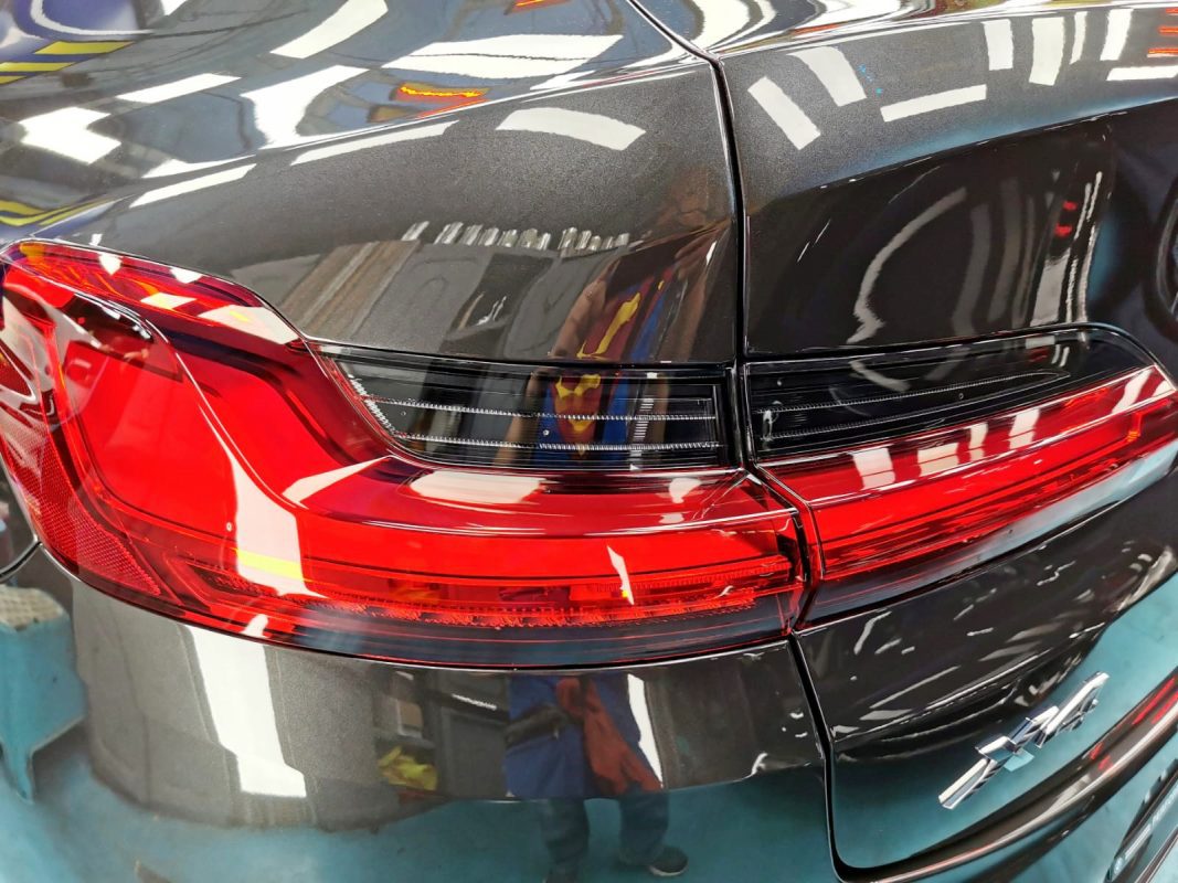 The coated bonnet of the BMW X4 under workshop lighting.