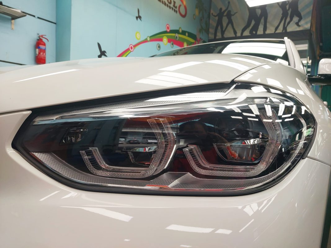 The BMW X4 parked in the workshop, freshly coated.