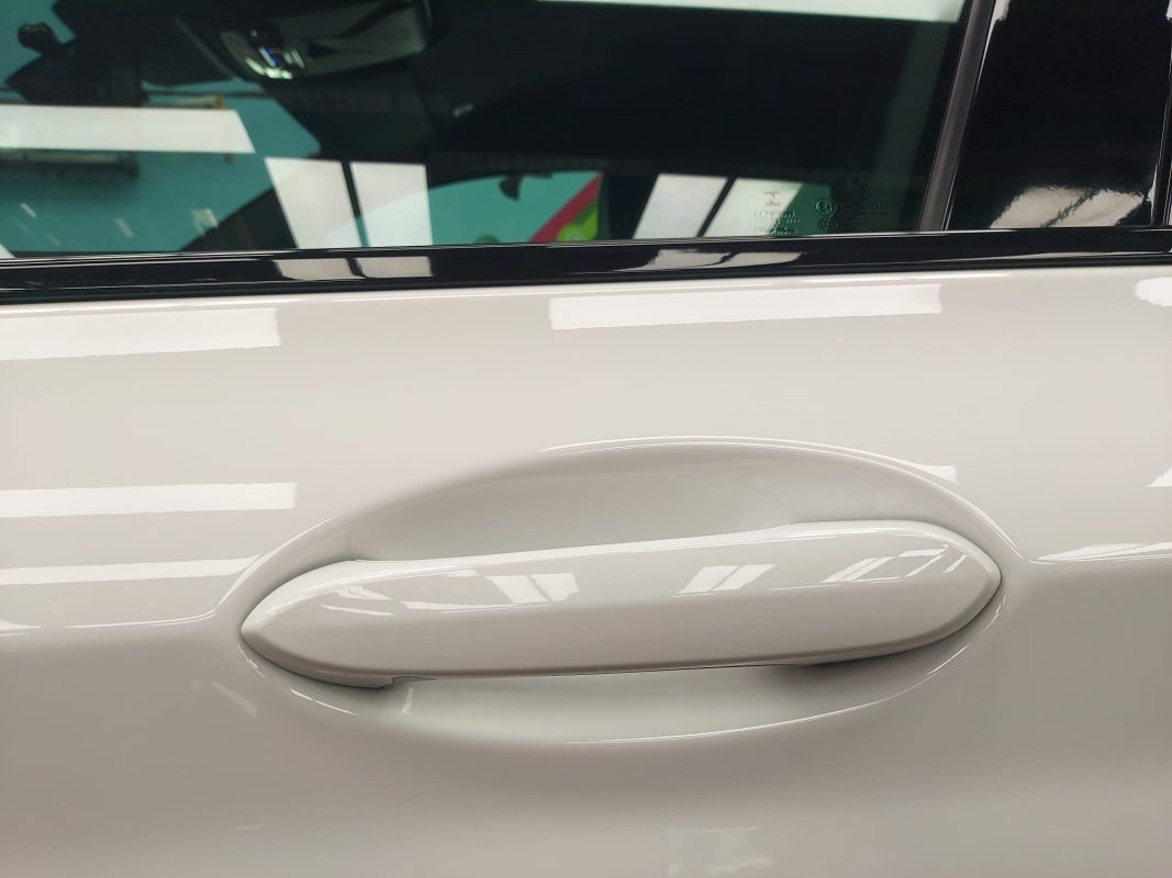 The coated bonnet of the BMW X4 under workshop lighting.