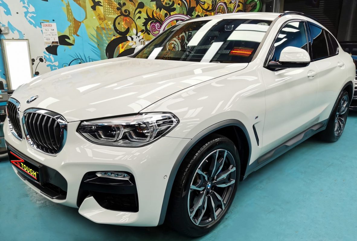 The BMW X4 from a side angle after the titanium coating.