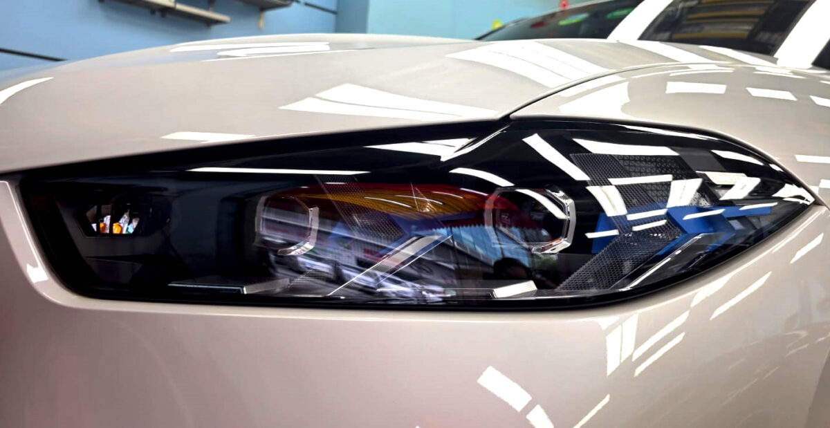 The X5's coated paintwork showing clean reflections.