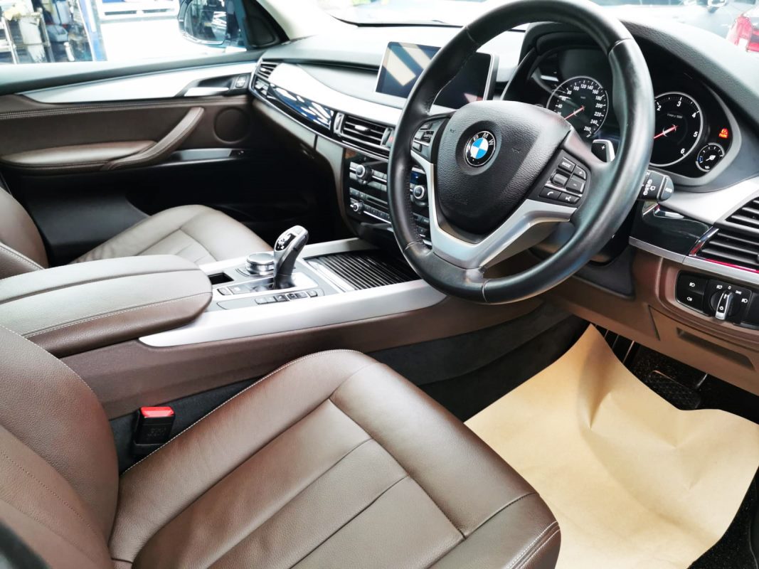The BMW X5 parked in the workshop, freshly coated.