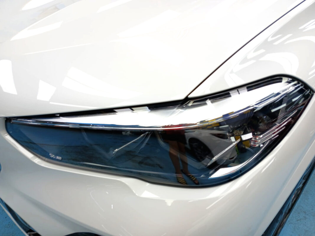 The X5's coated paintwork showing clean reflections.