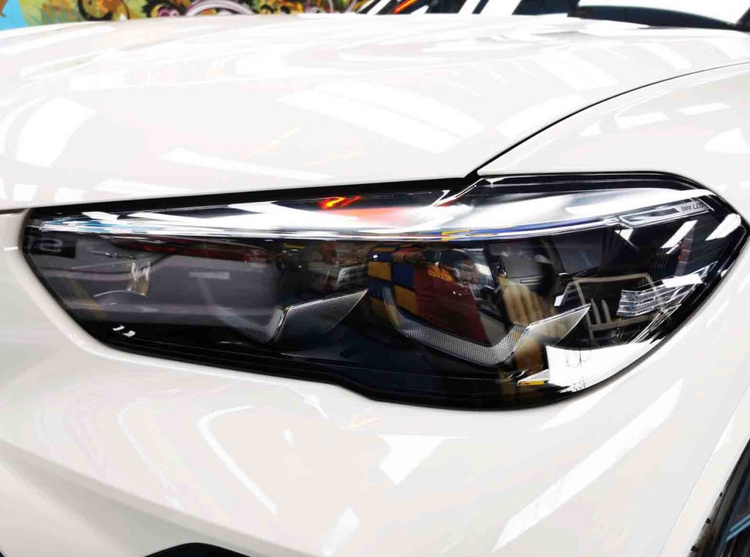 The X5's coated paintwork showing clean reflections.
