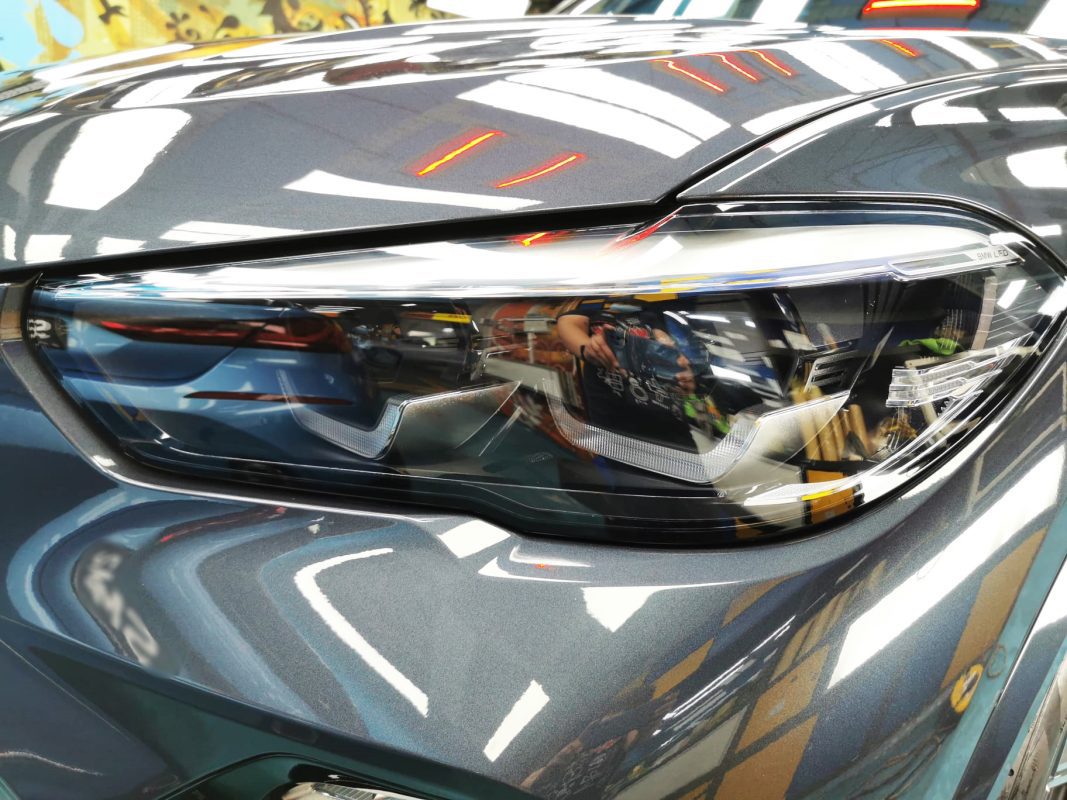 The X5's coated paintwork showing clean reflections.