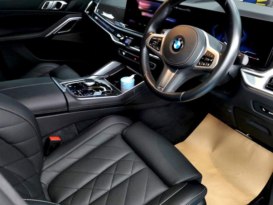 The BMW X6 parked in the workshop, freshly coated.