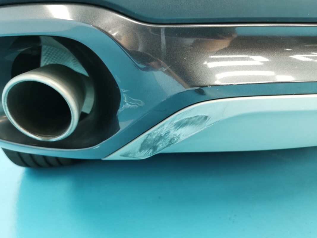 Another panel on the BMW X6 showing paint peel and surface blemishes.