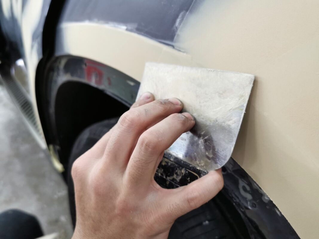 Filler and putty work on the BMW X6, surface blemishes being repaired.
