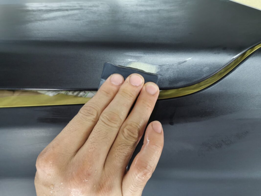 Wet-sanding another panel on the BMW X6.