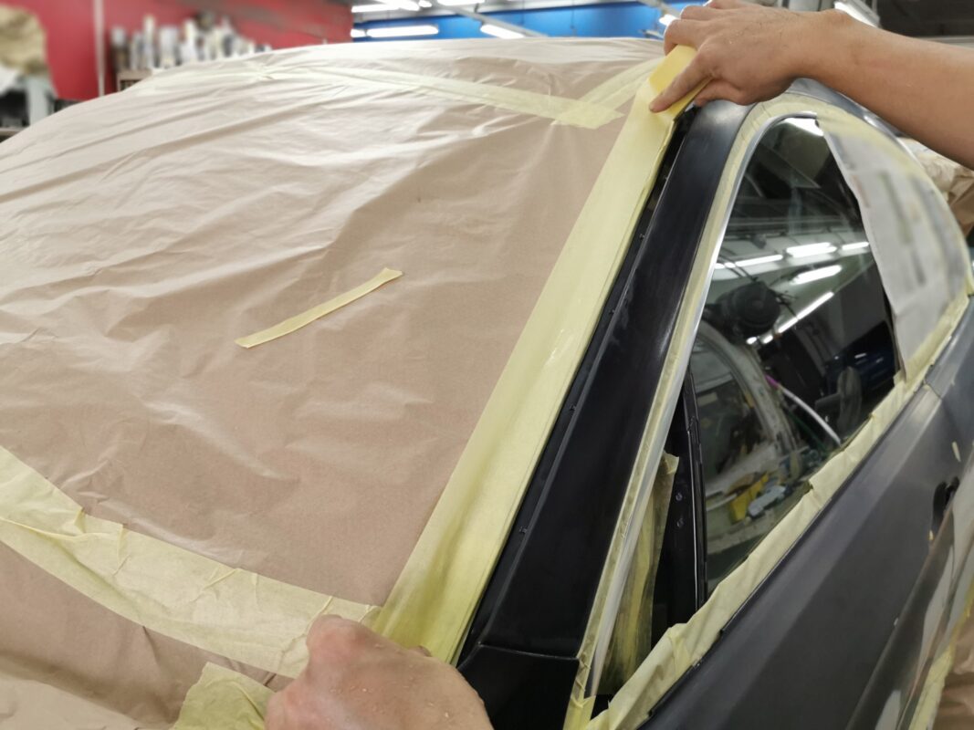 Non-painted surfaces masked on the BMW X6 before the spray booth.