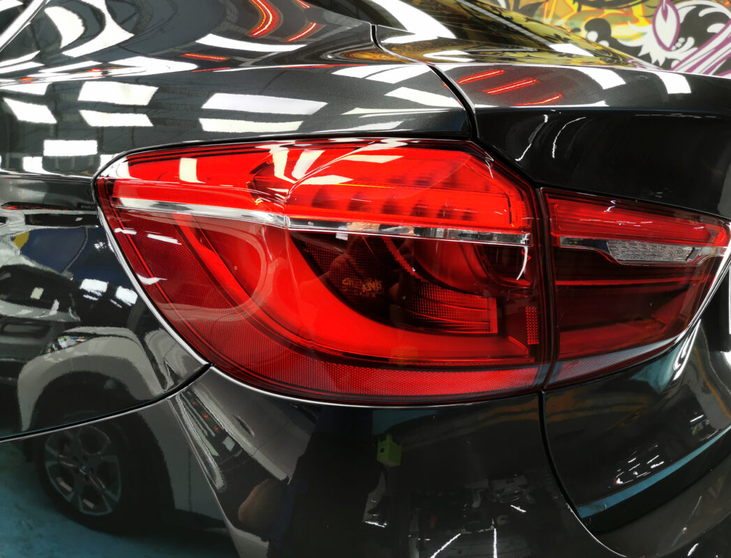 After: the BMW X6 resprayed to a deep, even gloss.