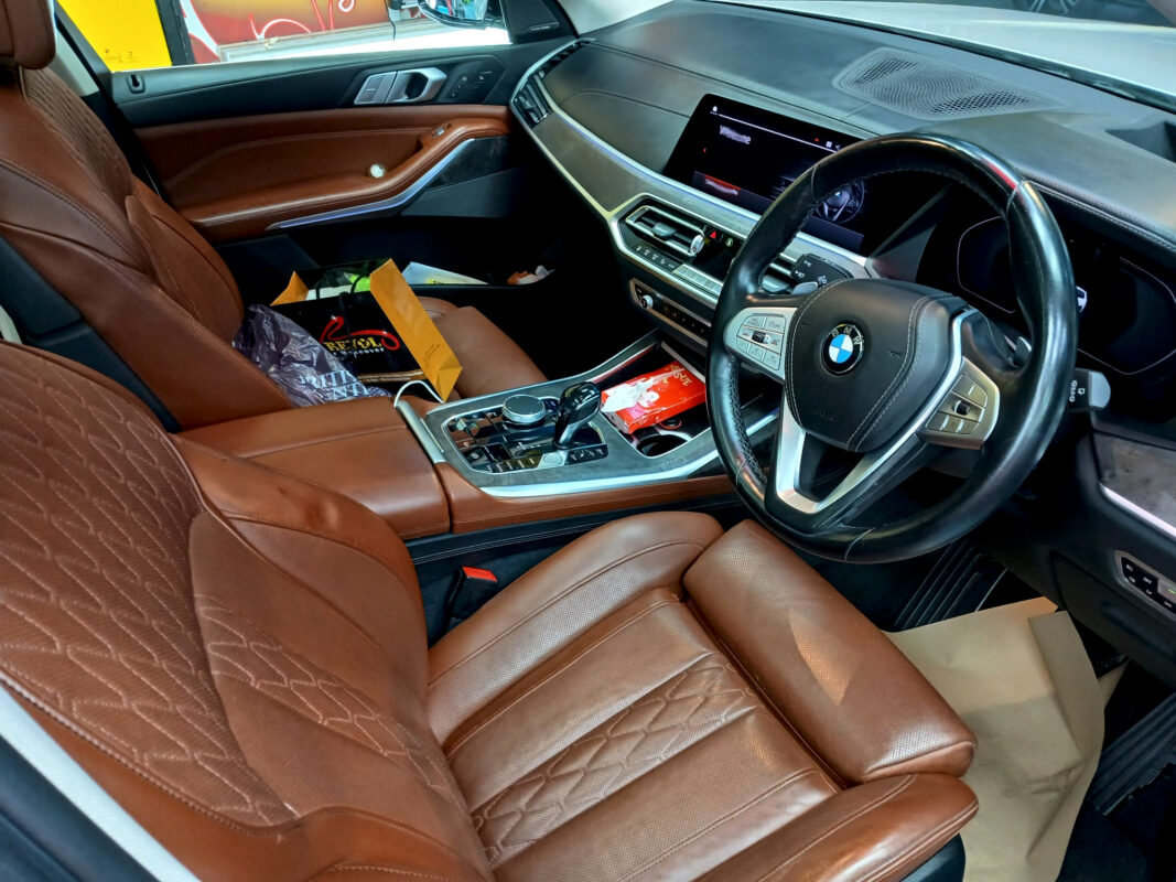 The BMW X7 parked in the workshop, freshly coated.