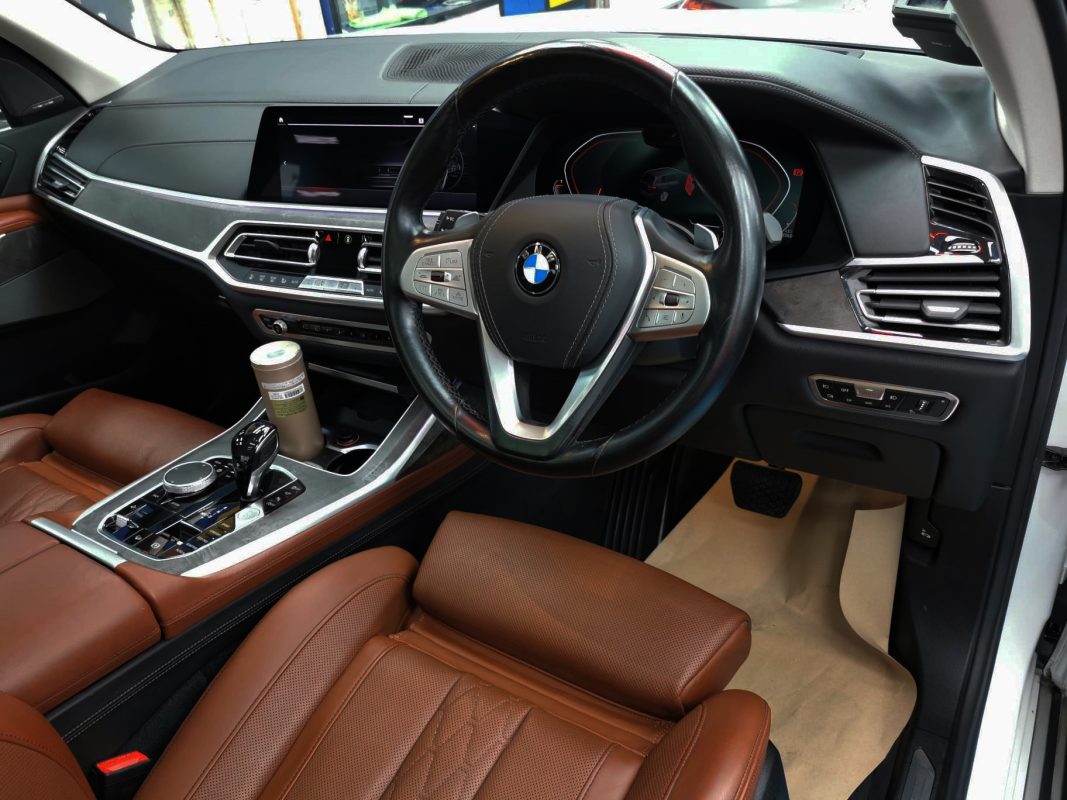 The BMW X7 parked in the workshop, freshly coated.