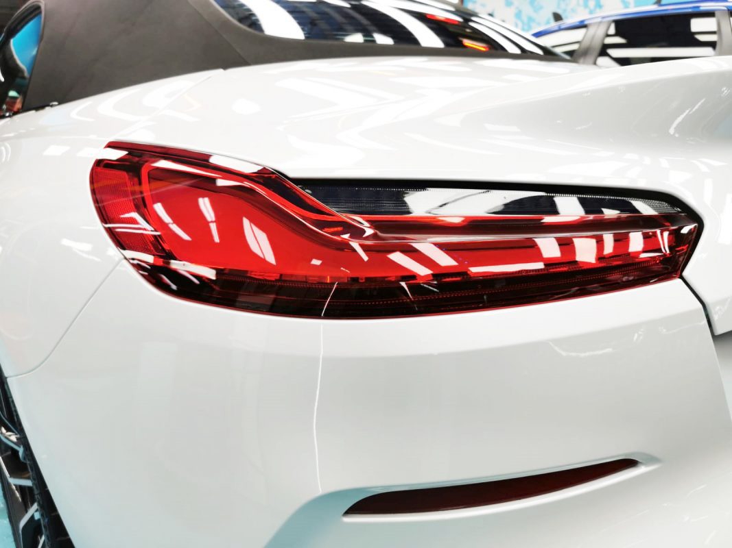 The coated bonnet of the BMW Z4 under workshop lighting.