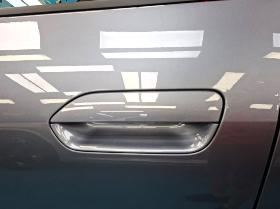 Door handle recess on the grey door panel.