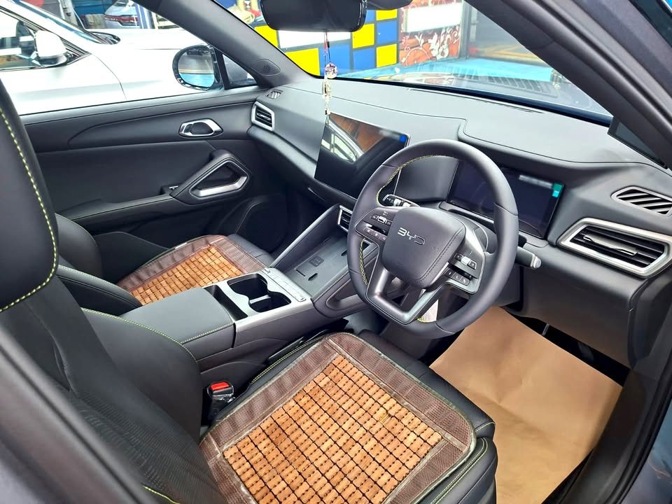 Front cabin of the Atto 2 with a woven seat cover and centre screen.
