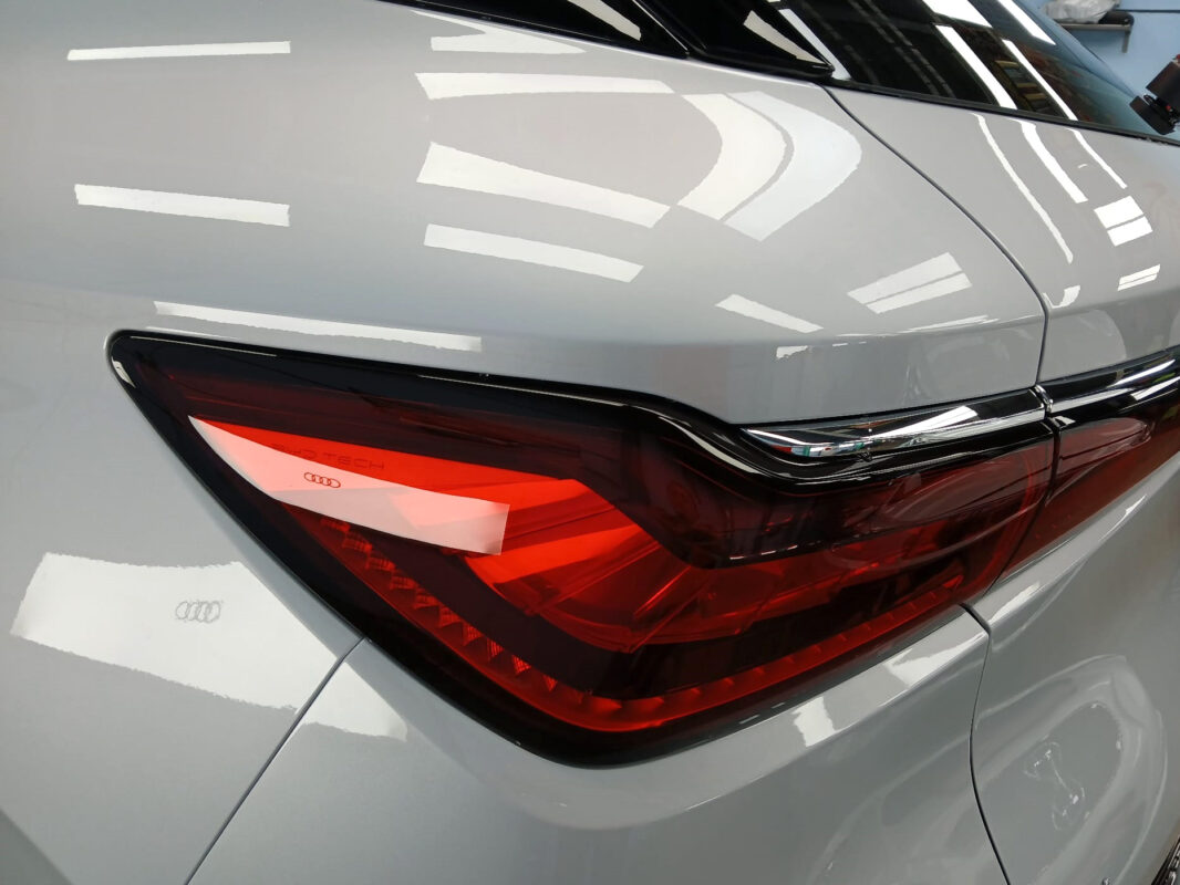 The coated bonnet of the BYD Atto 3 under workshop lighting.