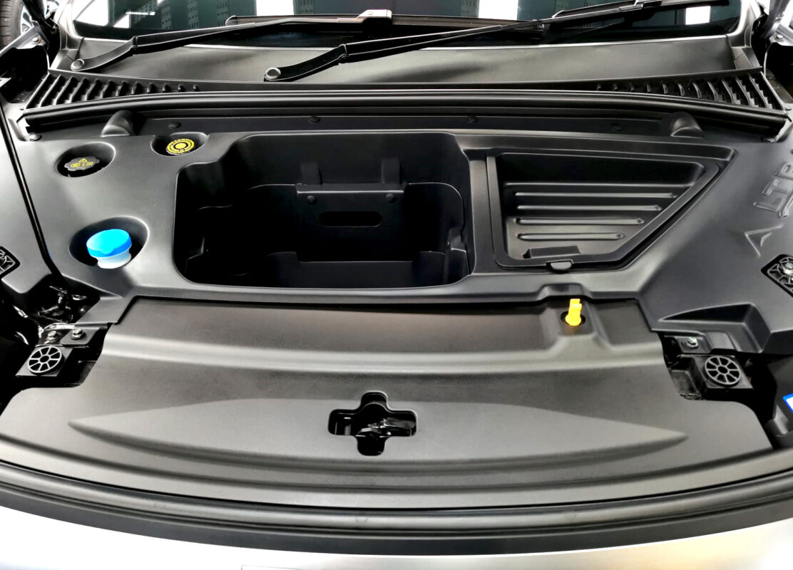 Reflections across the coated panels of the BYD Atto 3.