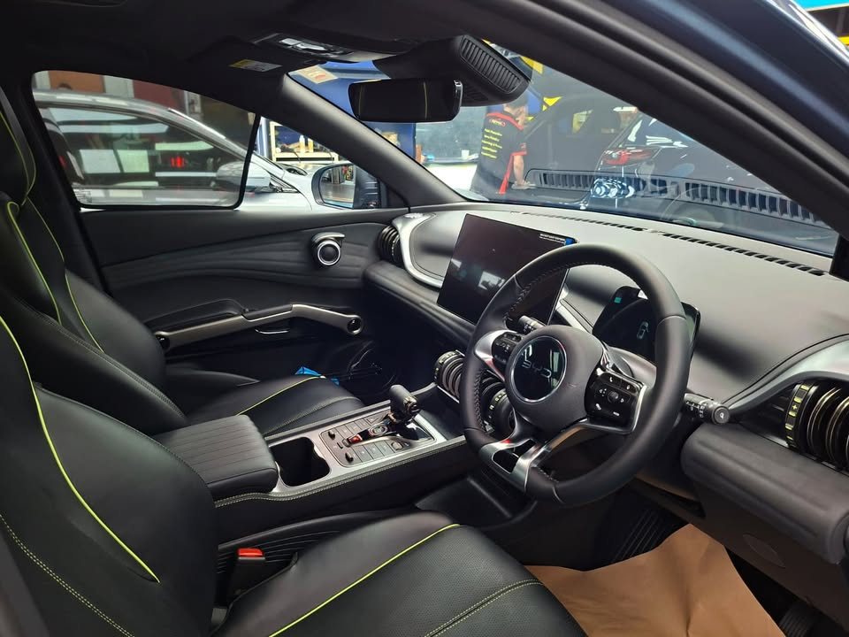 BYD Atto 3 cabin with black seats, steering wheel and dashboard screen.